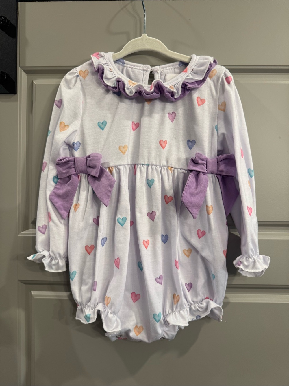 Simply Scarlett Smocks Baby Heart Print Ruffle Romper with Purple Bows